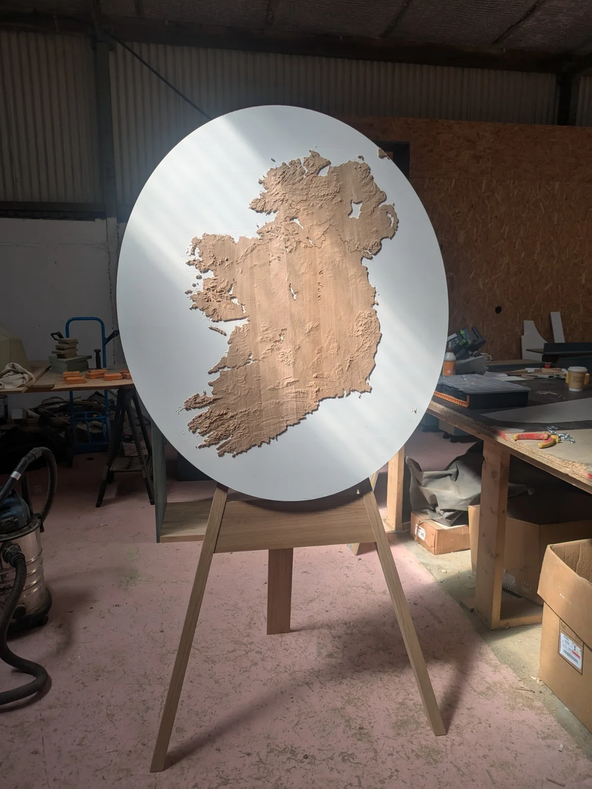Elliptical oak terrain model on white Hanex in the workshop before framing
