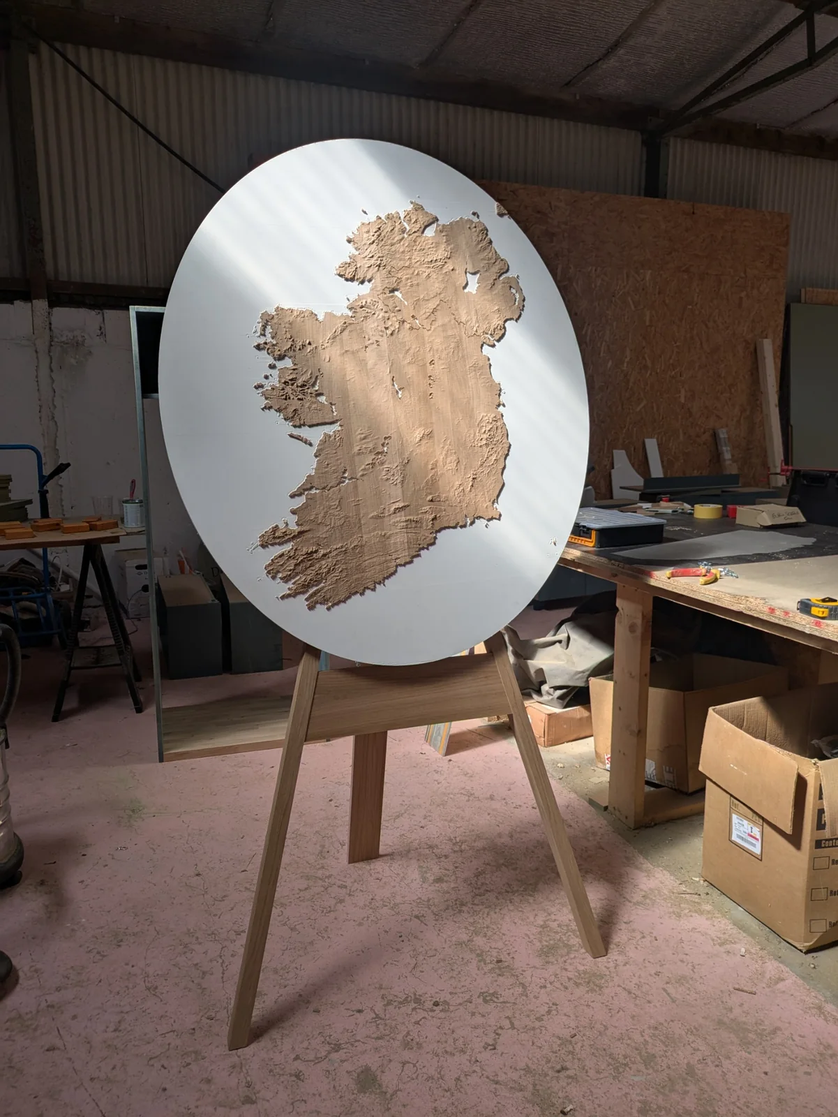 The unframed elliptical Ireland model catching the workshop light