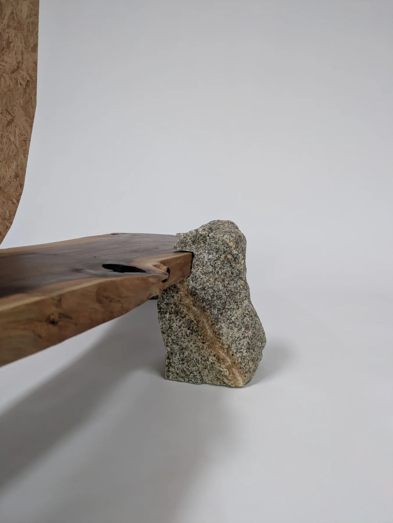 The notched walnut slab fitted into a granite support