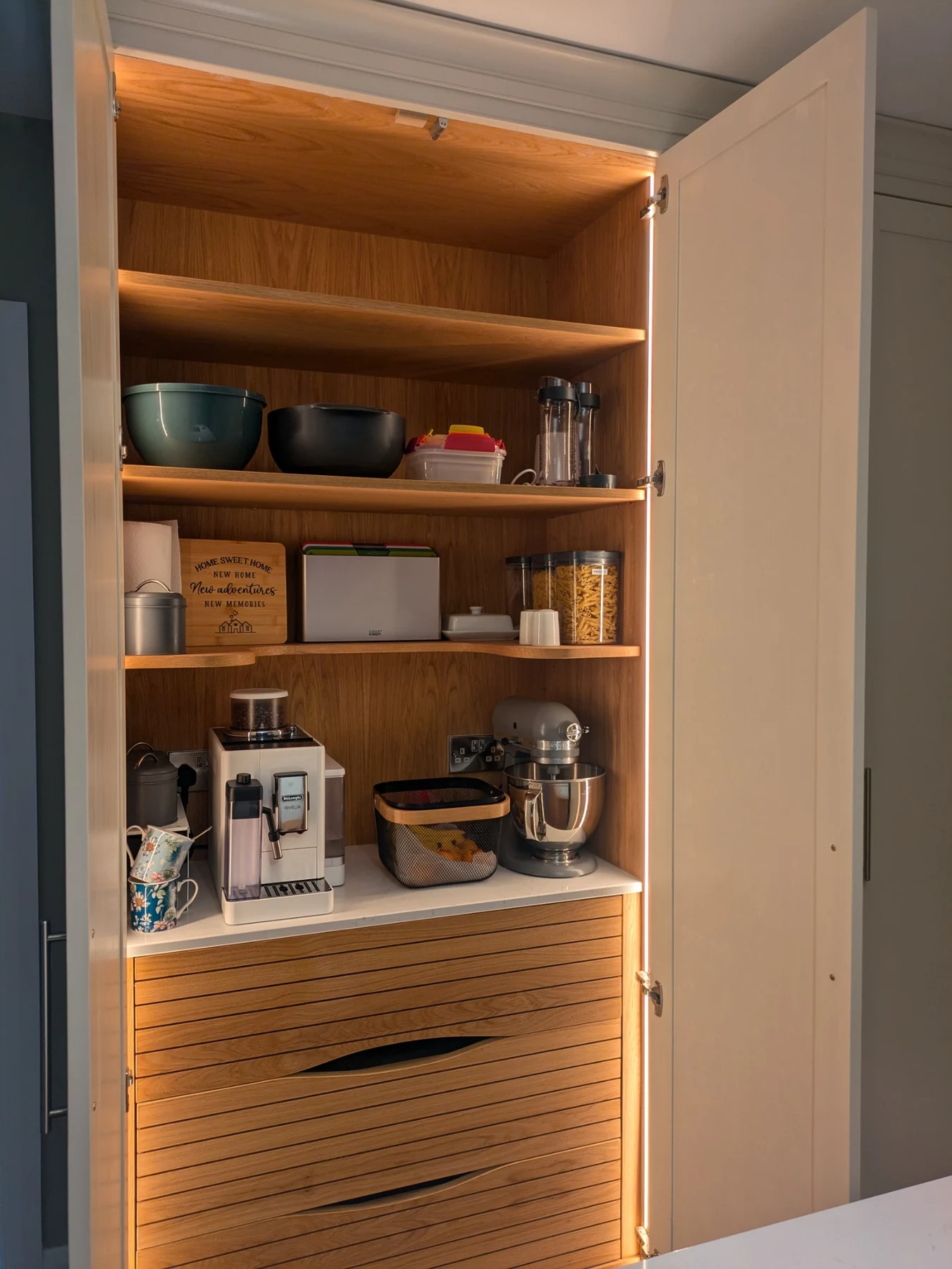 Custom oak pantry with grain matched drawers and LED lighting