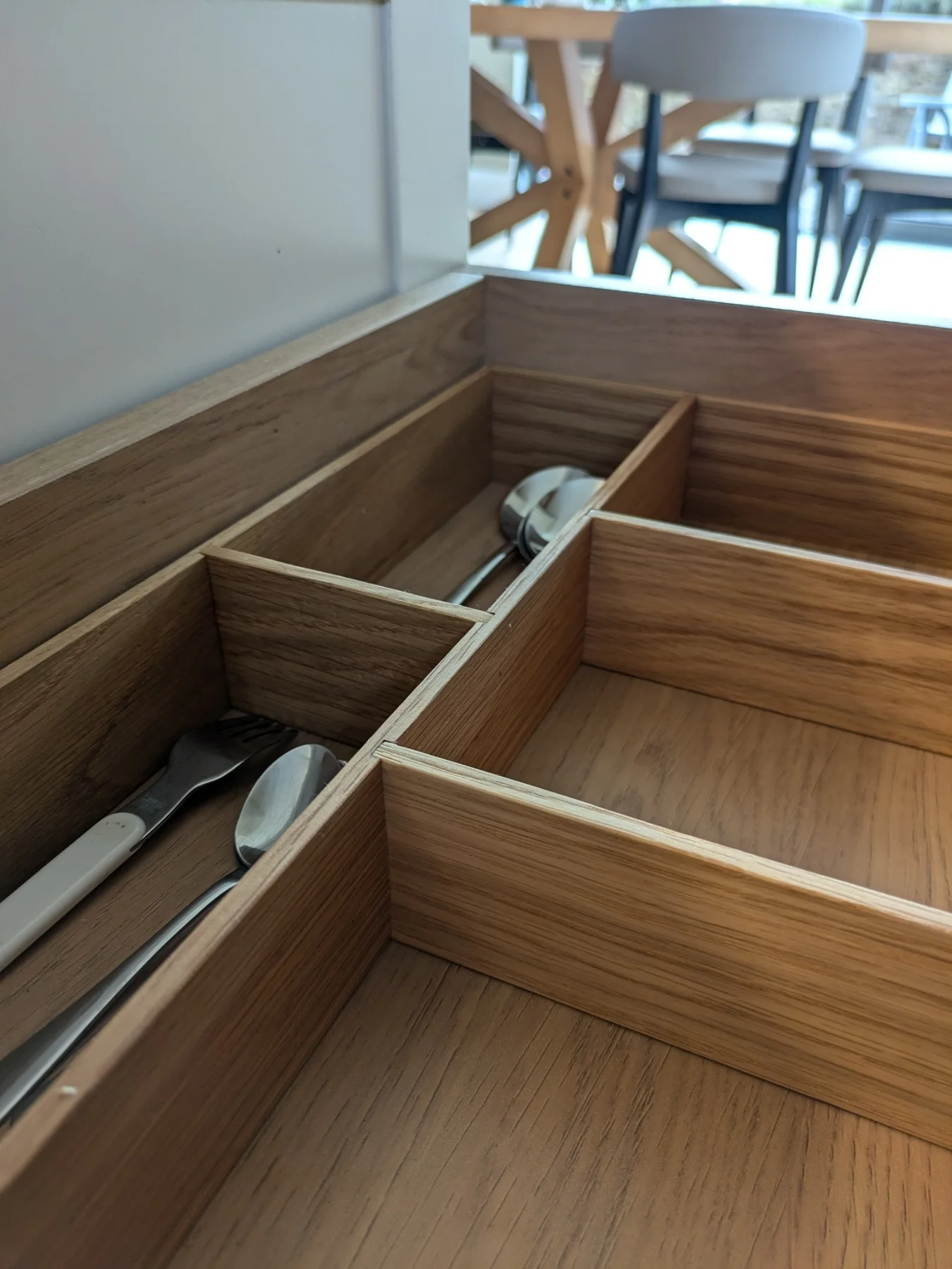 A custom oak cutlery insert with fitted compartments