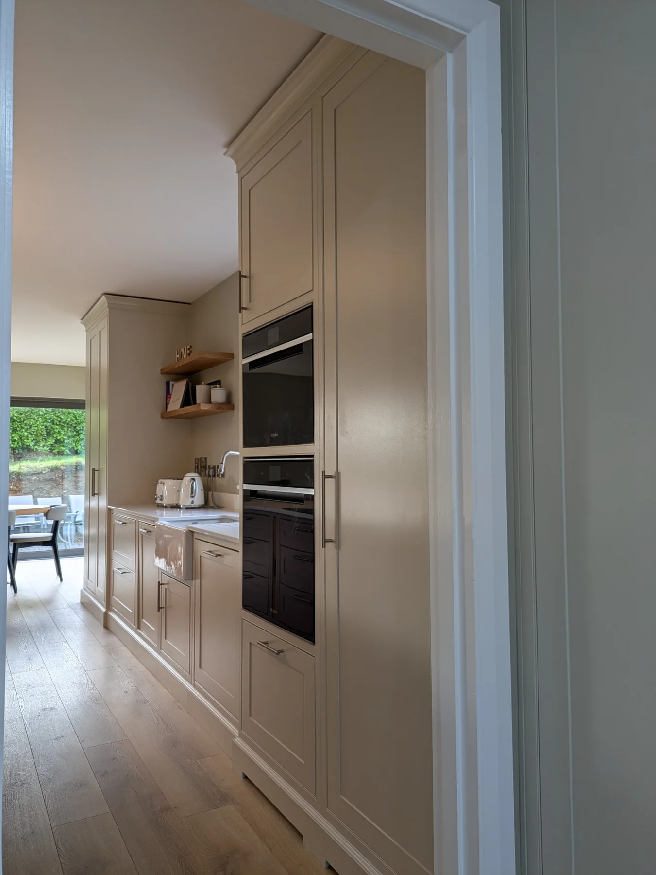 Tall in-frame cupboards with built-in ovens and traditional cornice