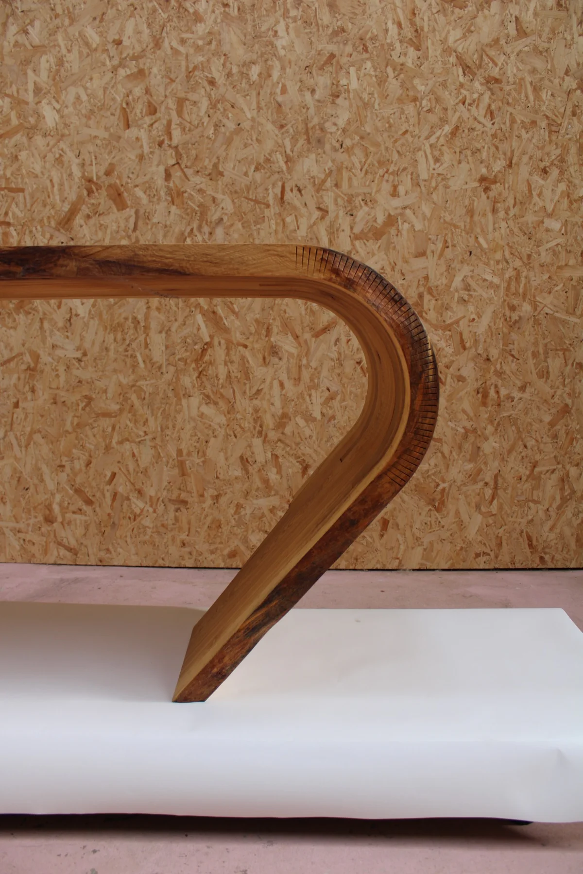 Side profile of the oak slab bending down to form the desk support