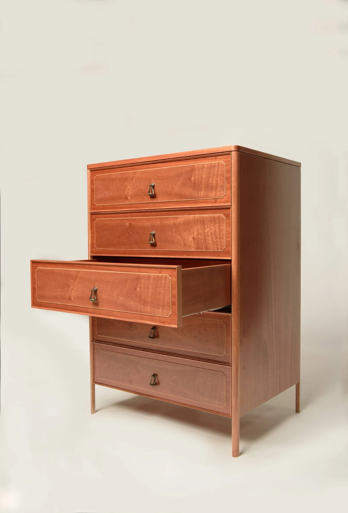 A mahogany dresser with one drawer open, showing the storage and raised legs