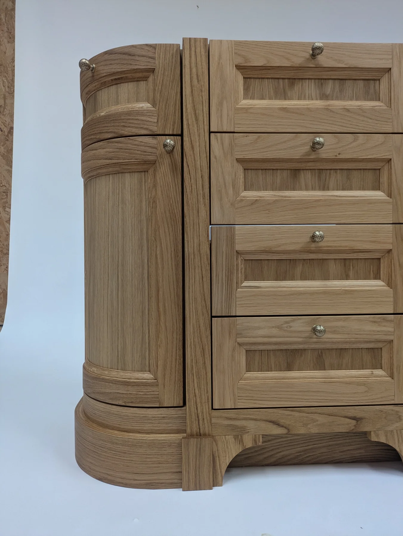 Close view of the curved oak cupboard front and central drawers