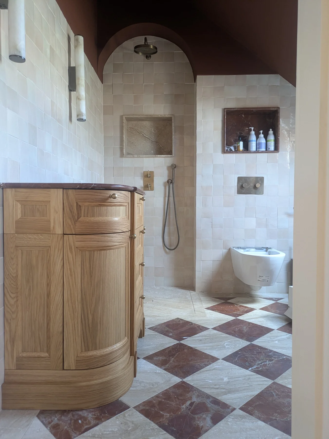The oak vanity installed in a bathroom with patterned floor tiles