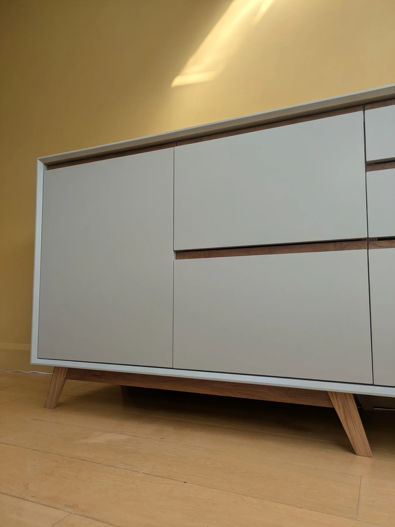 A closer view of the hand-painted sideboard fronts framed by the oak reveal