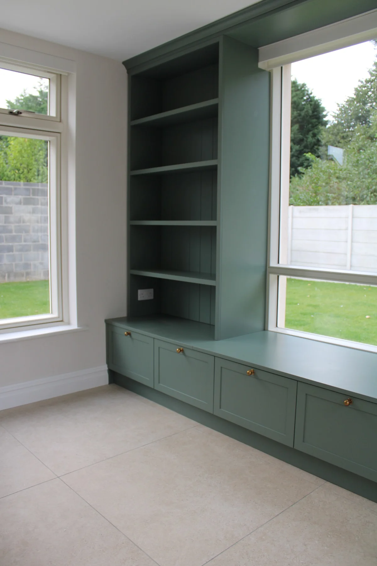 Painted shelves and lower cupboards beside the kitchen window