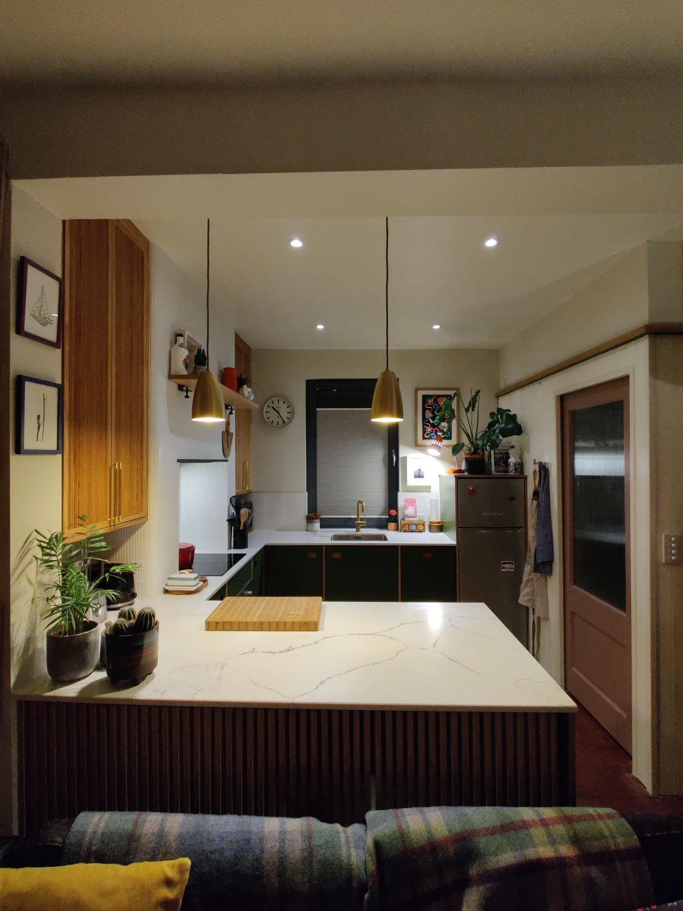 The kitchen peninsula with a reeded oak front, viewed towards the sink