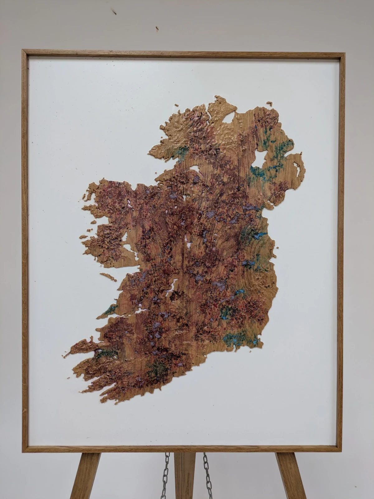 Framed coloured Ireland terrain model displayed on an easel