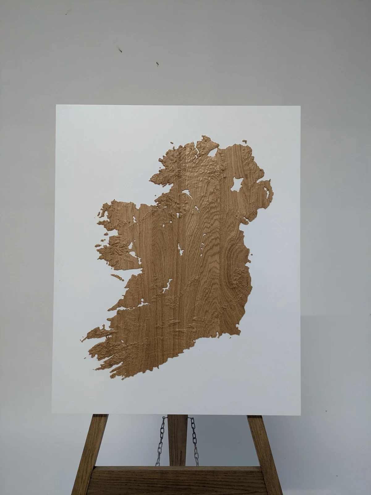 Natural oak relief model of the full island of Ireland on a white backing